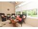 Enclosed lanai with wicker seating, blinds, and views of the surrounding landscape at 1442 Carlow Cir, Ormond Beach, FL 32174