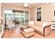 Bright living room with hardwood floors and a sliding glass door to the lanai at 1442 Carlow Cir, Ormond Beach, FL 32174