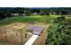 Aerial view of home with a long driveway and green lawns in a neighborhood lined with trees and golf course at 15190 Cr-565A, Clermont, FL 34711