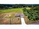 Aerial view features home with long driveway and lawns in a neighborhood surrounded by trees and blue skies at 15190 Cr-565A, Clermont, FL 34711