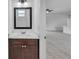 Chic half-bath with modern fixtures, marble counters, and dark wood cabinetry at 15190 Cr-565A, Clermont, FL 34711