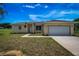 Charming single-story home showcasing a manicured lawn and attached two-car garage at 15190 Cr-565A, Clermont, FL 34711