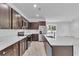 Modern kitchen featuring stainless steel appliances, quartz countertops, and dark wood cabinets at 15190 Cr-565A, Clermont, FL 34711