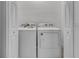 Modern laundry room features a washer, dryer, and white doors under bright lighting for convenience at 15190 Cr-565A, Clermont, FL 34711