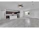 Spacious open-concept living area with a modern kitchen, tile floors, and abundant natural light at 15190 Cr-565A, Clermont, FL 34711