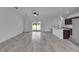 Bright living room with modern tile flooring, ceiling fan, and sliding glass doors to the outdoor area at 15190 Cr-565A, Clermont, FL 34711