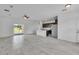 Open-concept living space features a modern kitchen, tile floors, and sliding glass doors at 15190 Cr-565A, Clermont, FL 34711
