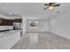 Open-concept living room featuring sleek stainless steel appliances, and a window with natural light at 15190 Cr-565A, Clermont, FL 34711