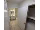 Neutral bathroom with a shower-tub combination, vanity, and tile floor plus a laundry closet with washer at 1600 Big Tree Rd # L1, South Daytona, FL 32119