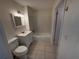 Bathroom featuring white vanity, tiled tub, and neutral color scheme at 1600 Big Tree Rd # L1, South Daytona, FL 32119