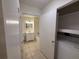 Neutral bathroom with a shower-tub combination, vanity, and tile floor plus a laundry closet with washer at 1600 Big Tree Rd # L1, South Daytona, FL 32119