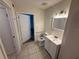 Full bathroom with white vanity, toilet, shower-tub, and tile floors under decorative vanity lighting at 1600 Big Tree Rd # L1, South Daytona, FL 32119