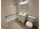 Standard bathroom featuring white fixtures, tiled shower-tub, and tiled floor at 1600 Big Tree Rd # L1, South Daytona, FL 32119