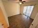 This bedroom has laminate flooring and a sliding glass door to a patio at 1600 Big Tree Rd # L1, South Daytona, FL 32119