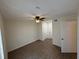 This bedroom has a ceiling fan and laminate flooring at 1600 Big Tree Rd # L1, South Daytona, FL 32119