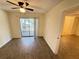 This bedroom has laminate flooring and a sliding glass door to a patio at 1600 Big Tree Rd # L1, South Daytona, FL 32119