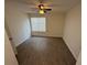 Bright, empty bedroom featuring clean floors, a ceiling fan and a large window for ample light at 1600 Big Tree Rd # L1, South Daytona, FL 32119