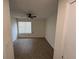 Bright, empty bedroom featuring clean floors, a ceiling fan and a large window for ample light at 1600 Big Tree Rd # L1, South Daytona, FL 32119