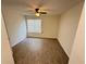 Bright, empty bedroom featuring clean floors, a ceiling fan and a large window for ample light at 1600 Big Tree Rd # L1, South Daytona, FL 32119