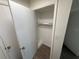 A small, organized closet with shelving and fresh paint at 1600 Big Tree Rd # L1, South Daytona, FL 32119