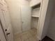 Storage closet with shelving adjacent to the front entryway at 1600 Big Tree Rd # L1, South Daytona, FL 32119