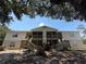 Two-story home with stairs and screened patios offers multiple outdoor spaces for residents at 1600 Big Tree Rd # L1, South Daytona, FL 32119
