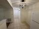 Hallway with tiled floor leading to various rooms, natural lighting, neutral colored walls at 1600 Big Tree Rd # L1, South Daytona, FL 32119