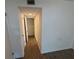 This hallway leads to a bedroom and has laminate flooring at 1600 Big Tree Rd # L1, South Daytona, FL 32119