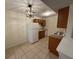 Kitchen with tiled floor and wooden cabinets, including appliances like fridge, stove, sink at 1600 Big Tree Rd # L1, South Daytona, FL 32119