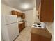 Compact kitchen featuring white appliances and tiled flooring at 1600 Big Tree Rd # L1, South Daytona, FL 32119