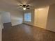 The living room features wood floors, a ceiling fan, a window, and a front door at 1600 Big Tree Rd # L1, South Daytona, FL 32119