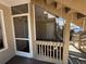A screened patio with a white door and ceiling fan is perfect for relaxing or storage, stairs on the right at 1600 Big Tree Rd # L1, South Daytona, FL 32119