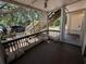 Spacious screened porch view showing the stairs, landscaping, and parking at 1600 Big Tree Rd # L1, South Daytona, FL 32119