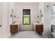 Elegant bathroom with double vanities, modern fixtures, a view to the outdoors, and clean lines at 1624 Turnbull Crossings Dr, New Smyrna Beach, FL 32168