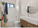 Chic bathroom featuring a modern vanity, round mirror, and stylish patterned shower curtain at 1624 Turnbull Crossings Dr, New Smyrna Beach, FL 32168
