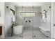 This bathroom boasts a tub and seamless glass shower with multiple shower heads at 1624 Turnbull Crossings Dr, New Smyrna Beach, FL 32168