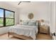 Comfortable bedroom with a wooden bed frame, neutral colors, and bright window views at 1624 Turnbull Crossings Dr, New Smyrna Beach, FL 32168