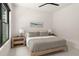 Cozy bedroom features a minimalist design with a wooden bed frame and soft, neutral colors at 1624 Turnbull Crossings Dr, New Smyrna Beach, FL 32168