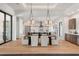 Dining area showcasing modern light fixtures and an open view to the gourmet kitchen and other living areas at 1624 Turnbull Crossings Dr, New Smyrna Beach, FL 32168