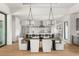 Elegant dining room featuring modern light fixtures and open access to the gourmet kitchen at 1624 Turnbull Crossings Dr, New Smyrna Beach, FL 32168