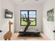 Bright, spacious exercise room with a treadmill, large window, and minimalist decor at 1624 Turnbull Crossings Dr, New Smyrna Beach, FL 32168