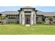 Beautifully landscaped home featuring stone accents and a covered entryway with a black double door at 1624 Turnbull Crossings Dr, New Smyrna Beach, FL 32168