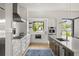 Modern kitchen with white cabinets, stainless steel appliances, and center island with barstool seating at 1624 Turnbull Crossings Dr, New Smyrna Beach, FL 32168