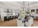 Bright, modern kitchen with an island, barstool seating and a dining area with contemporary light fixtures at 1624 Turnbull Crossings Dr, New Smyrna Beach, FL 32168