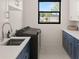 Clean and efficient laundry room with modern appliances and ample cabinet space at 1624 Turnbull Crossings Dr, New Smyrna Beach, FL 32168