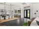 Spacious living area with a double door entry and views of a modern kitchen and dining area at 1624 Turnbull Crossings Dr, New Smyrna Beach, FL 32168