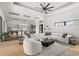 Large living room with a modern fireplace and a large white sectional couch, and an oversized ceiling fan at 1624 Turnbull Crossings Dr, New Smyrna Beach, FL 32168