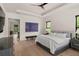 Comfortable main bedroom with king bed, hardwood floors, tray ceilings, and a modern interior design at 1624 Turnbull Crossings Dr, New Smyrna Beach, FL 32168
