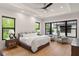 Serene main bedroom featuring tray ceilings, natural light, and two comfortable sitting chairs at 1624 Turnbull Crossings Dr, New Smyrna Beach, FL 32168