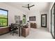 Modern home office setup with large windows, contemporary furniture, and plenty of workspace at 1624 Turnbull Crossings Dr, New Smyrna Beach, FL 32168
